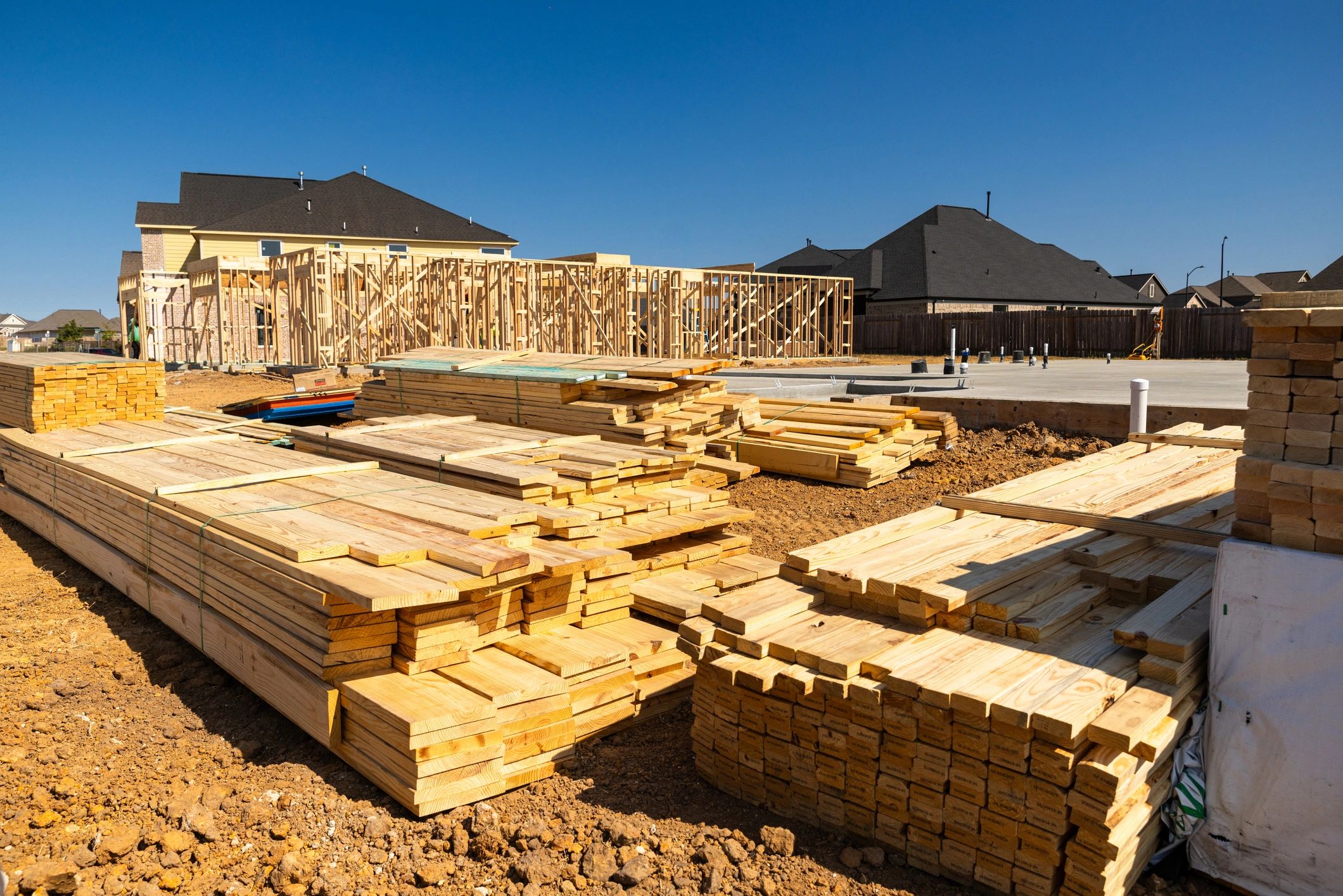 On-site framing materials staged for a residential build